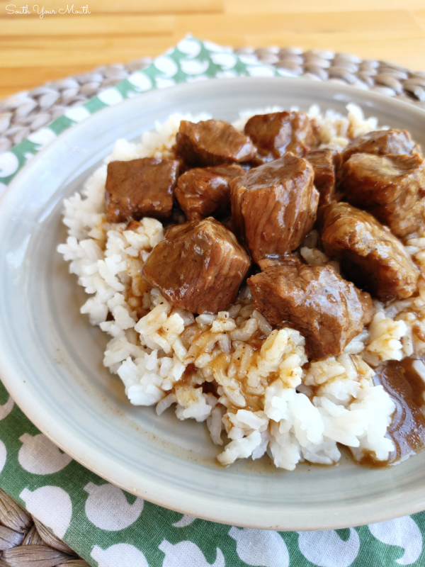 Stewed Beef (Beef Tips) with Gravy! A tried-and-true family recipe for stew beef or beef tips slow-cooked until tender with a rich gravy served over rice, mashed potatoes or noodles.