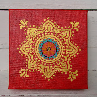 mini gold mandala on red painting