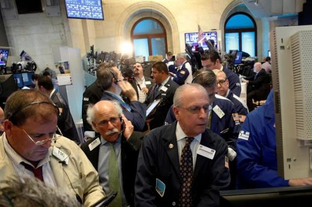 Traders work on the floor of the New York Stock Exchange 