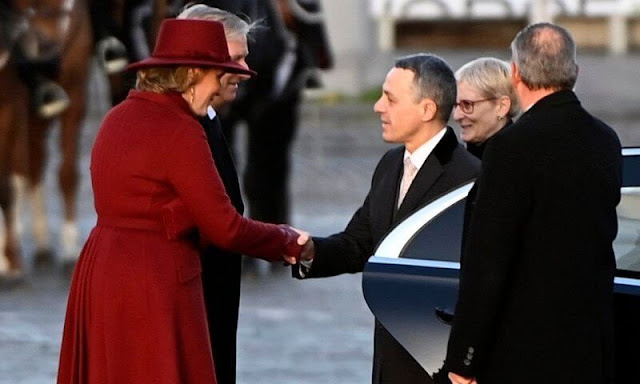 Queen Mathilde wore a wine red burgundy coat and wine red burgundy dress by Naatan. First Lady Paola Rodoni Cassis