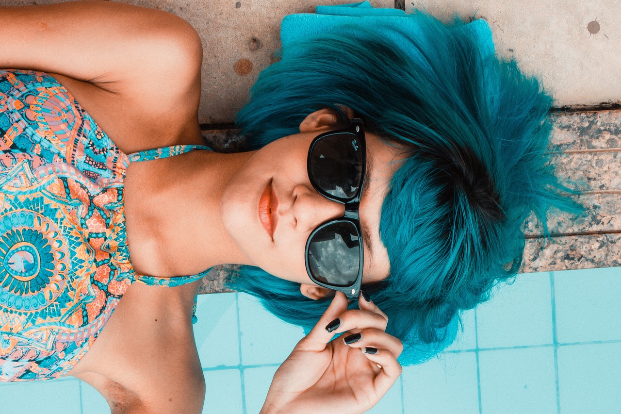A lady on Shades with blue dyed hair