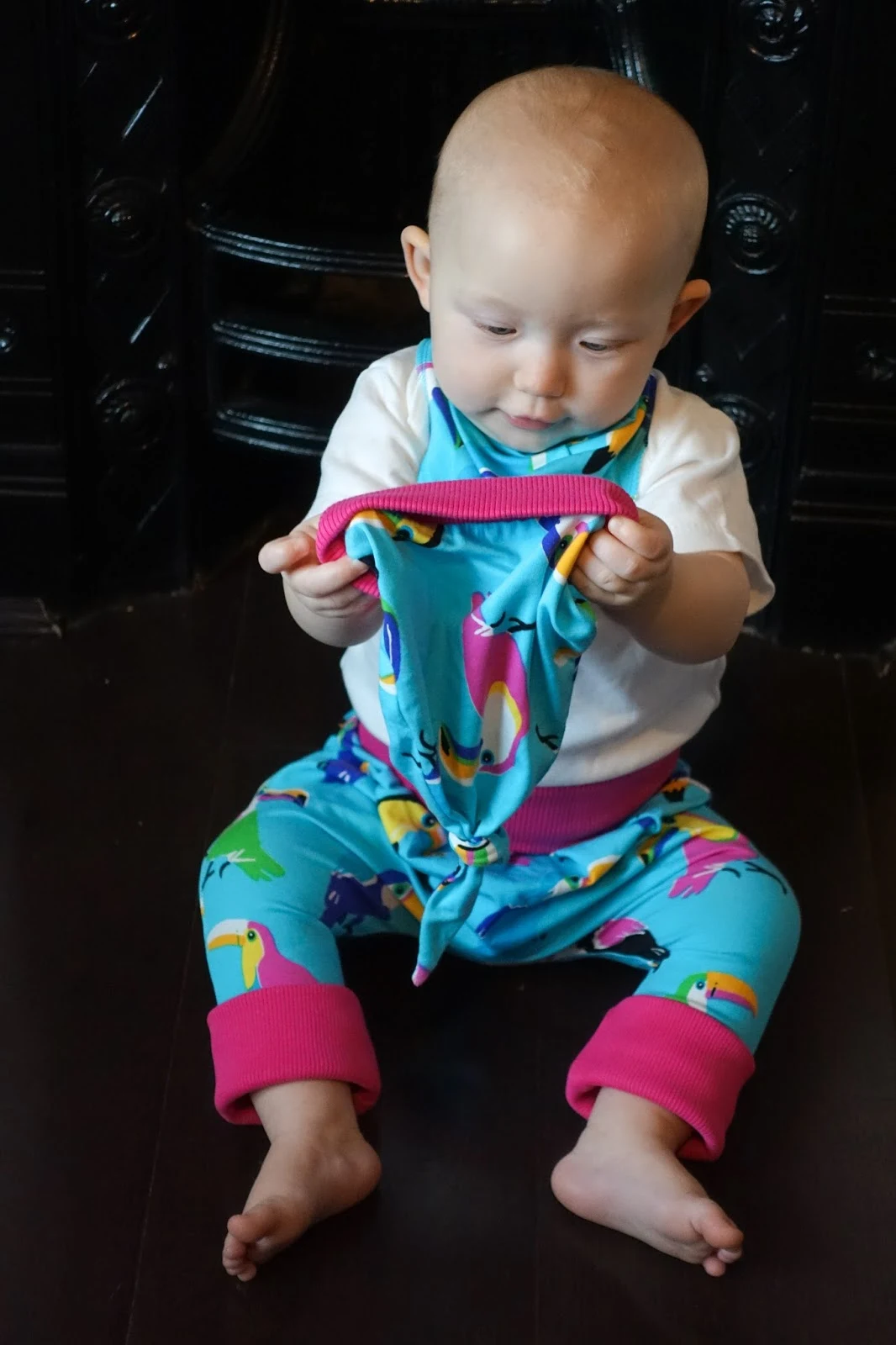 Baby looking at the Funky Giraffe Funky Toucan print hat