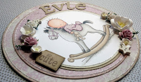 Circular pink baby girl card with baby on rocking horse (image from LOTV)