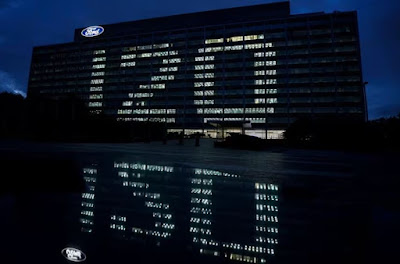 Ford World Headquarters in Dearborn lit up the night with “120” featured in lighted offices on a lights-out background.