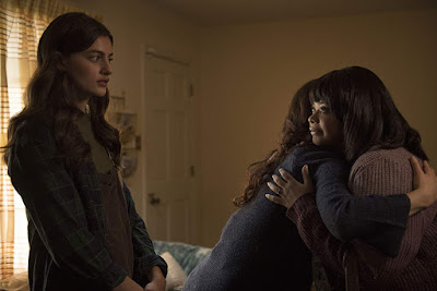 Diana Silvers watches as Octavia Spencer menacingly hugs her mom, played by Juliette Lewis, in the 2019 horror film Ma