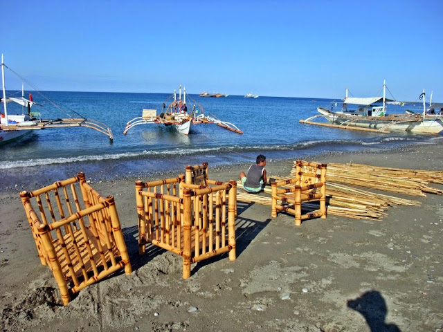 bamboo baby cribs and a bamboo chair laid out on the beach before transporting to the market at San Jose Occidental Mindoro