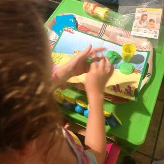 Girl working with Play-Doh stamps