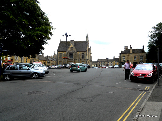 Stow-on-the-Wold, Last stop in Cotswolds,Stow-on-the-wold was the last stop in Cotswolds and this was a bad decision on the part of the organizers because after the pastel prettiness of Bourton on the Water, Stow-on-the-Wold appeared pretty average. Historically, it is a market town that was situated at the convergence of many important roads. And even today, the main part of the town is the market. We only had 45 mins here and, therefore, not much time to explore. Though we had run out of things to do already after this time. The Market Square at the centre of the town. There were several cafes, antique shops and souvenir shops around the square and at the centre was the St Edward's Hall. Also, this was the only town where we didn't have anything to eat or drink. The time was too short. Hannah, our scamperer, is in a hurry to get to the next antique shop. While Kelsey McTexty and myself strolled behind. One of the modern looking streets leading into the market square. The street was totally out of character when compared to the visual appeal of rest of the town.The other side of the St. Edward's Hall. The Hall now houses the public library.This was the last stop in Cotswolds during our trip. However, there was one more stop and it was Shakespeare's Straford Upon Avon. Watch out for the next post.To read the previous posts in this series, click here: Bourton on the Water. Stow-on-the-Wold, UK, Cotswolds, St Edward's Hall, England