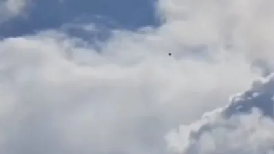 Image showing a black UFO sphere in the sky.