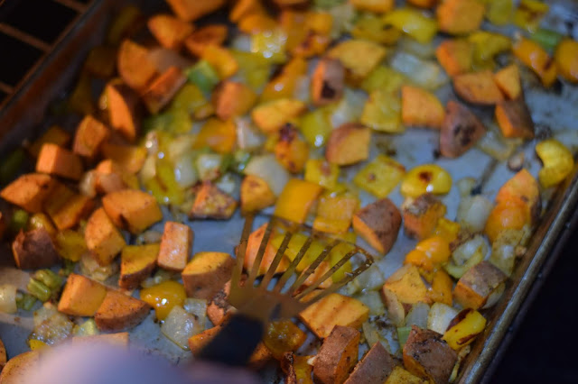 Stirring the roasting veggies halfway through the cooking process.  