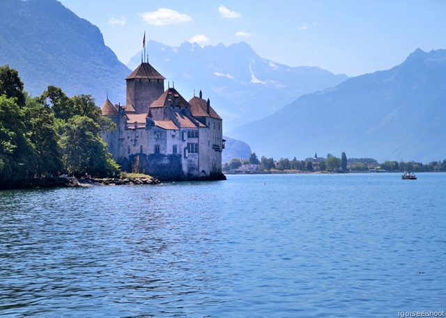 Walk along Montreux’s Flower-lined Promenade to Chateau de Chillon. Gorgeous view of Chillon Castle set on the shores of Lake Geneva with the Alps in the background.