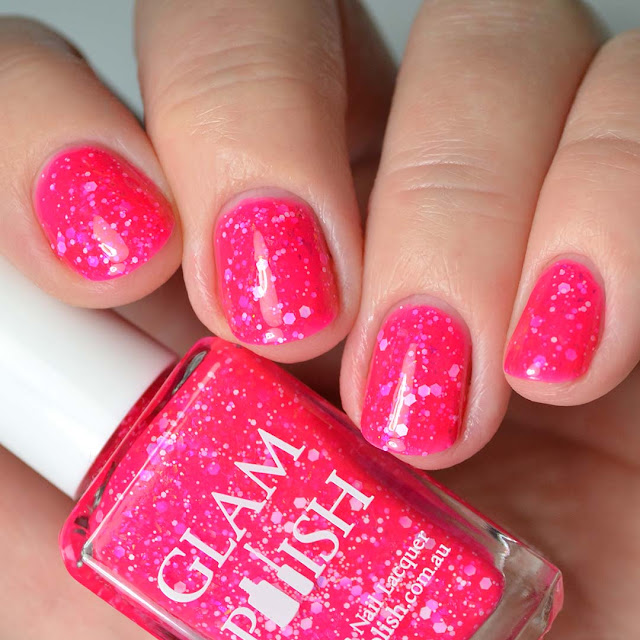 bright pink nail polish with glitter four finger swatch