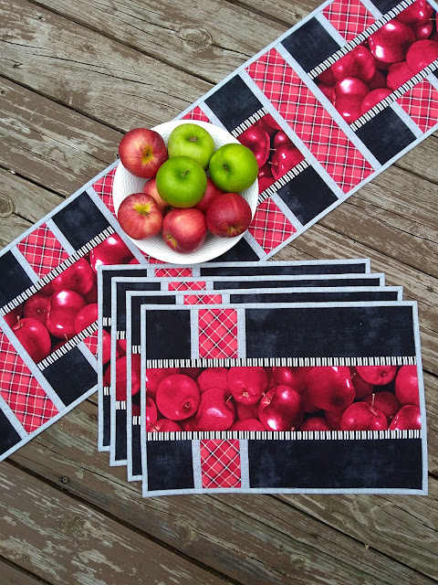placemats and table runner with apple print, red, grey and black fabric