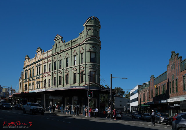 In full sun, the iconic two story triangular building on the corner of King and Wilson Street Newtown. Fujifilm X100VI in Newtown