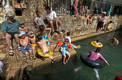 Israeli children enjoy the spring water of Nahal Prat, in the Judea Desert near the West Bank settlement of Alon, east of Jerusalem