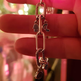 Hand with Pandora Millie Bobby Brown Bracelet Charms dangling