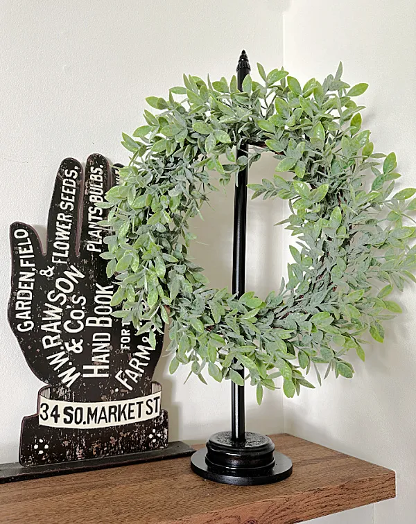 wreath with hand sign on mantel