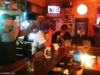 Guy at the bar connects several straws together to steel free beer from across the bar.