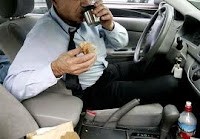 man driving while eating