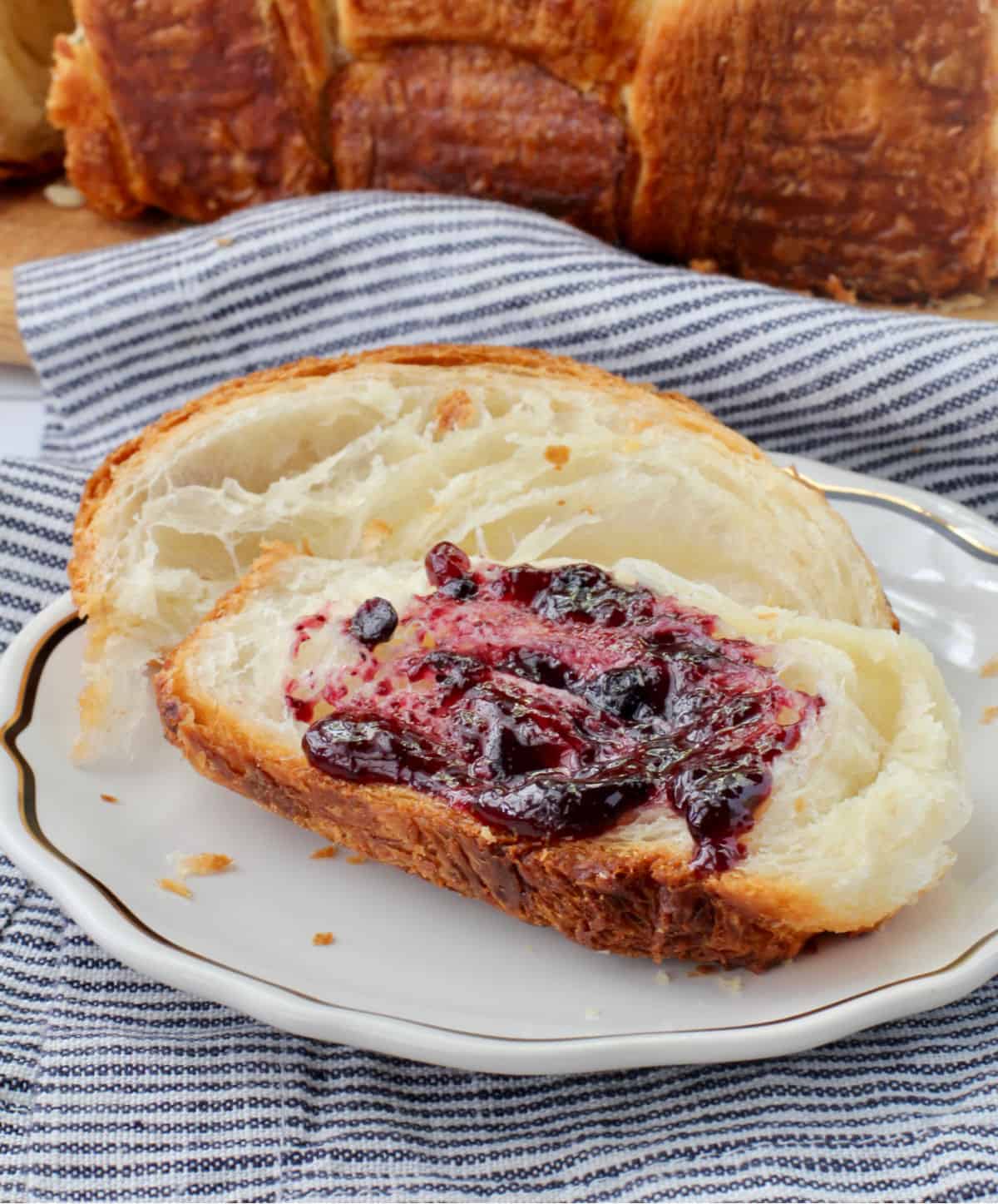 Croissant Bread slice with jam on it.