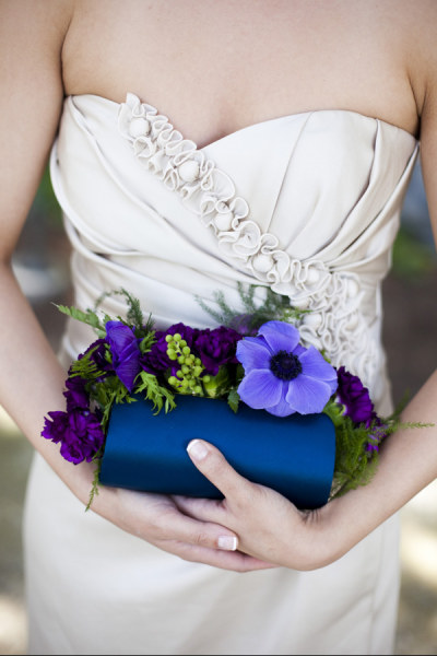 A bridesmaid holding a very unique clutch bouquet!