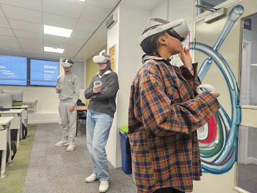 Three students wearing Virtual Reality headsets