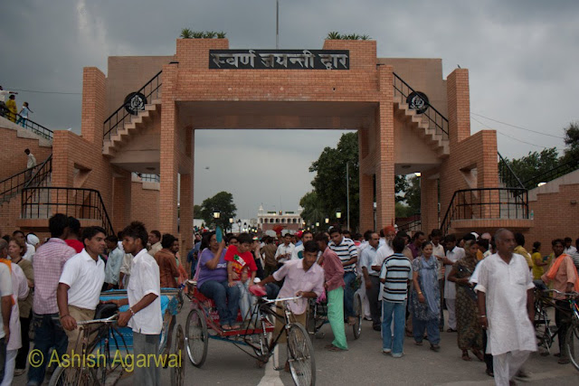 View though the middle of the stands building at the Wagah border between India and Pakistan, and a view of the Pakistani side