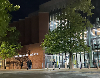 A photo of the outside of the Shakespeare North Playhouse at night.