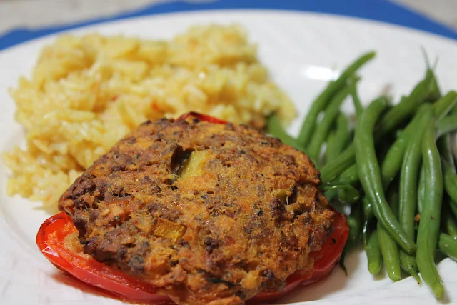 Ground beef, hot sausage and vegetables make the filling for this stuffed pepper.