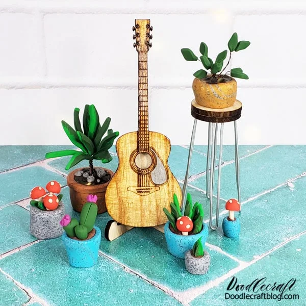 How to Make a Miniature Acoustic Guitar Studio!  This miniature guitar studio is one of my most favorite projects to date.   I love how this tiny little acoustic guitar turned out.   I love that mini hairpin leg stool.   I mostly love these little clay potted plants! 😉 😂Learn how to make a miniature acoustic guitar and potted plants for the miniature lover in your life!