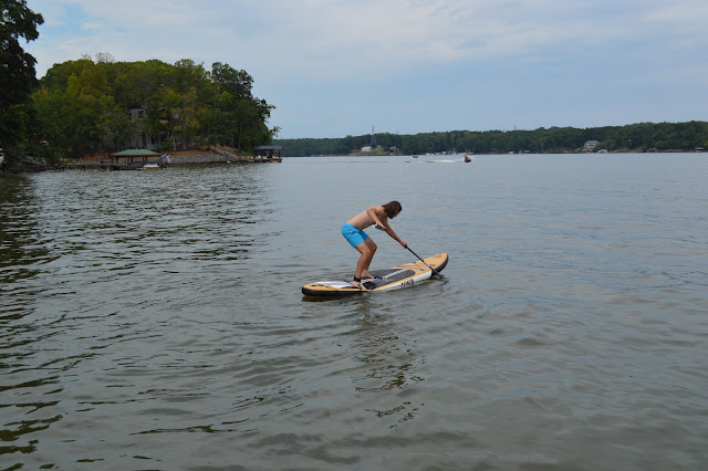 Andy getting ready to stand up fully on the paddleboard.