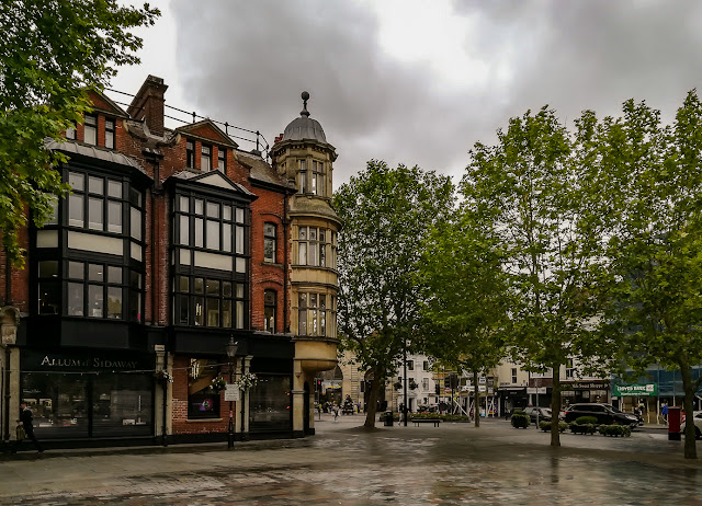 Photo of impressive architecture on the corner of Market Square on a wet day in Salisbury