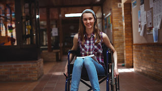 Smiling young woman sitting in wheelchair photo