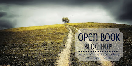 image of a hillside under a cloudy sky with a tree at the top with the logo for the Open Book Blog Hop.