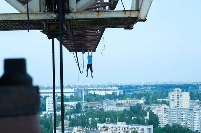 Man hanging from the crane 