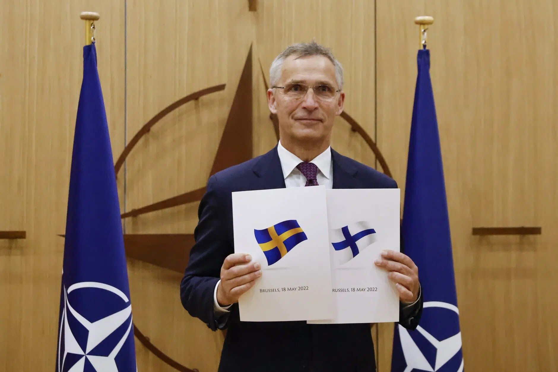 NATO Secretary-General Jens Stoltenberg displays Sweden and Finland’s applications for membership in the military alliance in Brussels, Belgium, on Wednesday May 18, 2022. (Johanna Geron, Pool via AP)