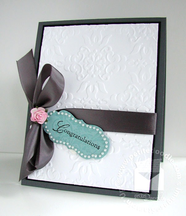 From the deep embossed damask background to the silky satin ribbon