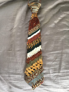 Tie striped with rows of feathers