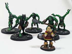A gang of five troll models with one 28mm character figure.