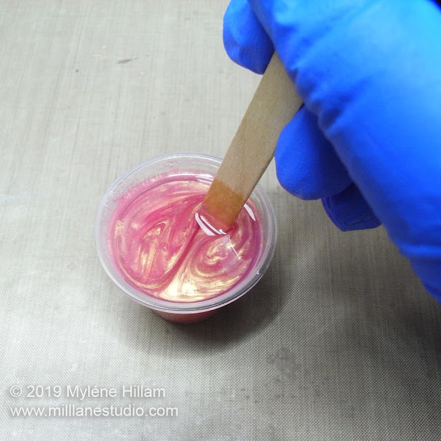 Mixing the resin with a wooden stir stick
