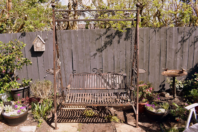 weather garden swing that needs restoration