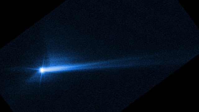 This image from the Hubble Space Telescope shows a split stream of dust and rock streaming off the asteroid Dimorphos nearly 12 days after the DART spacecraft smashed into it.  NASA, ESA, STSCI, HUBBLE