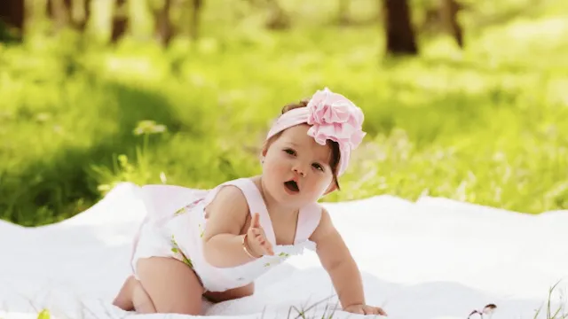 Bebê menina pousando para foto em um parque Nomes de Meninas Com J