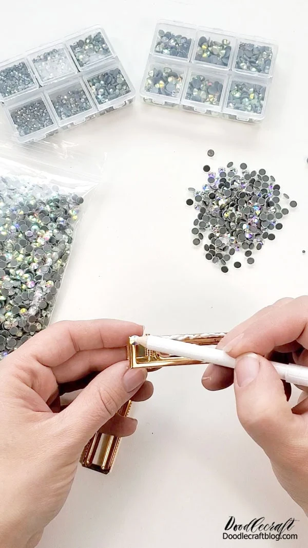 Step 3: Rhinestone Time!  Use the rhinestone picker, it's a very light tack pencil that allows you to pick up the rhinestones without using clumsy fingers. This is a game changer.    Then place rhinestones on the clip in the adhesive and the picker will easily release the rhinestone.