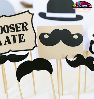 Photo booth props made from cardboard, including mustaches, glasses, and hats