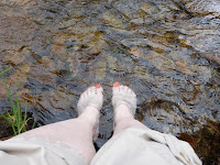 My feet in a stream, taken two years ago, to remind me that I have to craft new experiences now.