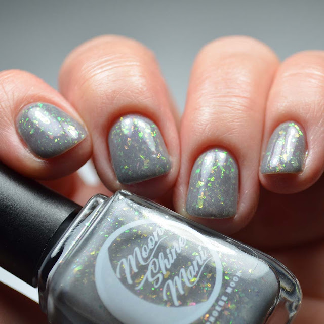 grey nail polish with flakies low light swatch