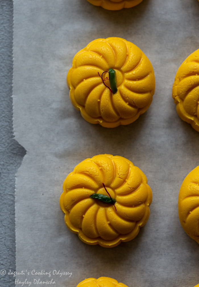 Mango peda placed on parchment paper.
