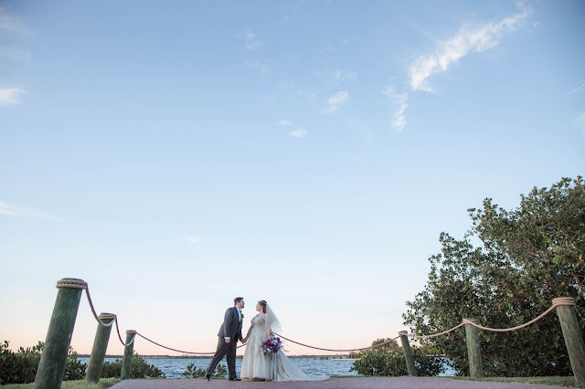 bride and groom candid moment by the water