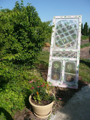 Or attach an old window frame above a window box to dress up the dreary wall 